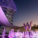 W Abu Dhabi - Yas Island's fountains at the entrance of the hotel with the W logo tinted in purple.