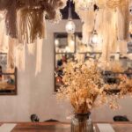 Lolla's downstair communal table with ropes, vintage style glassware and mirrored walls.
