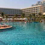 Main swimming pool and hotel building at InterContinental Ras Al Khaimah Mina Al Arab Resort