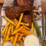 Neighbourhood Food Hall The Meating Room lamb chops with fries and a grilled green chilli.