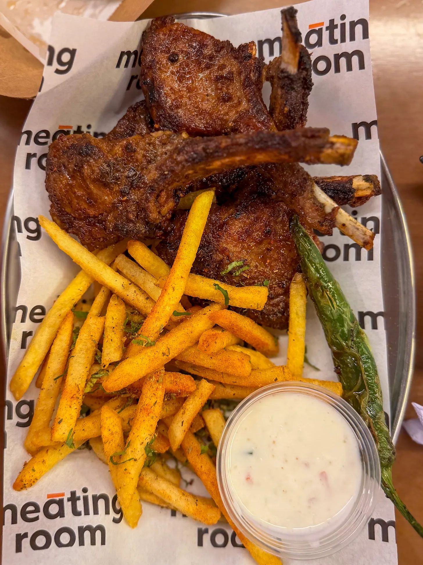 Neighbourhood Food Hall The Meating Room lamb chops with fries and a grilled green chilli.