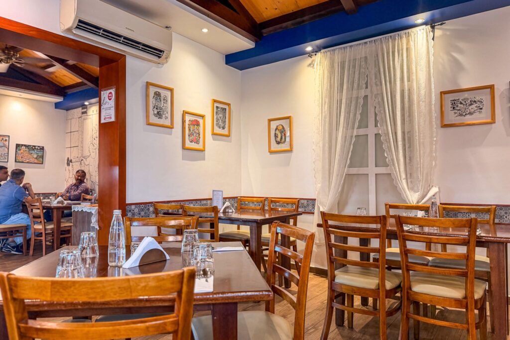 Interior dining room at Eric’s Restaurant in Karama with wooden tables and blue and white décor
