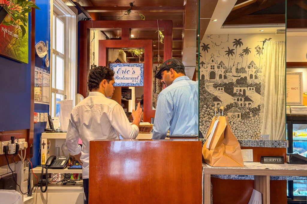 Staff at the front counter inside Eric’s Restaurant in Karama, Dubai