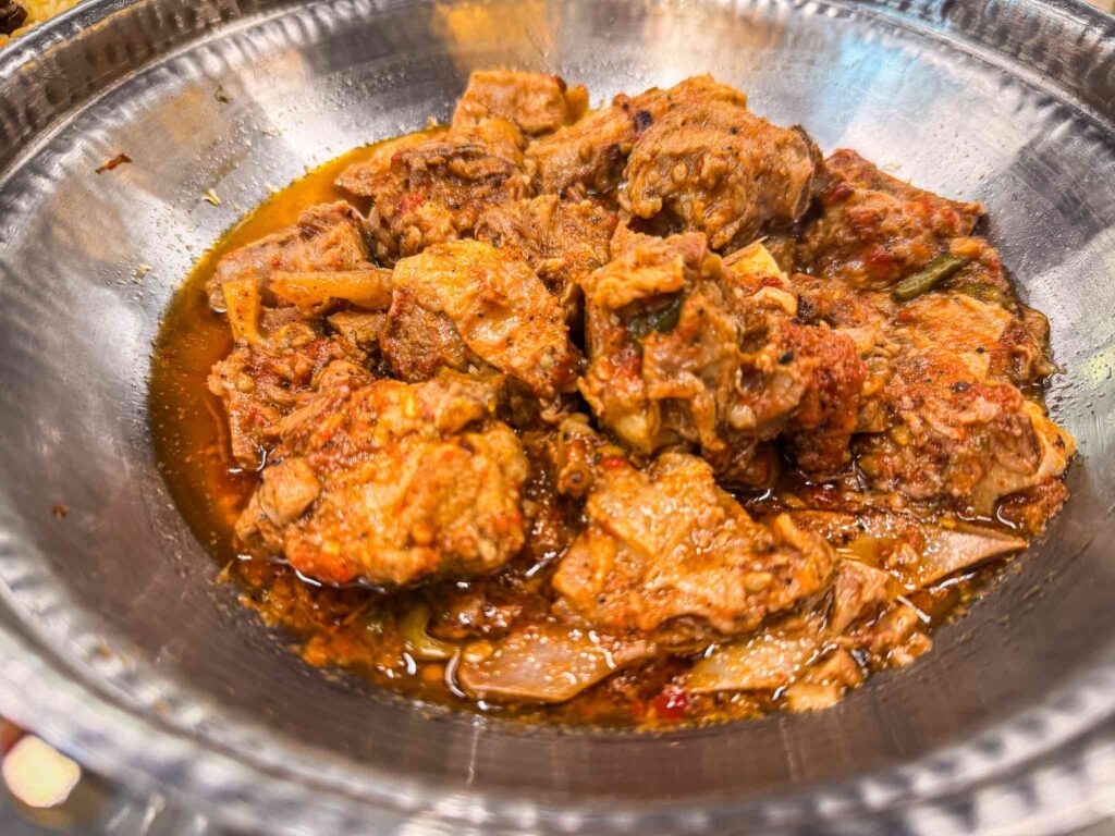 Half portion of Special Nisar Charsi Karahi, mutton on the bone in a thick tomato gravy, served in a steel karahi
