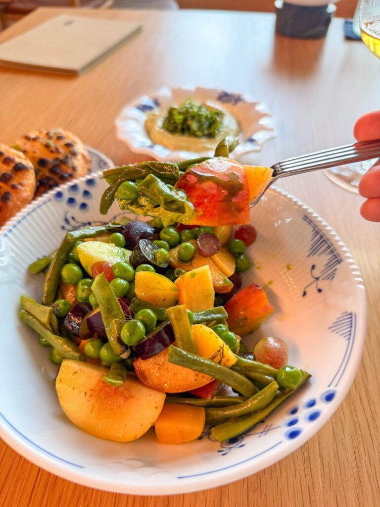 A forkful of peach, peas and grilled green beans lifted from the stone fruit and legume salad at Blue restaurant, Saadiyat