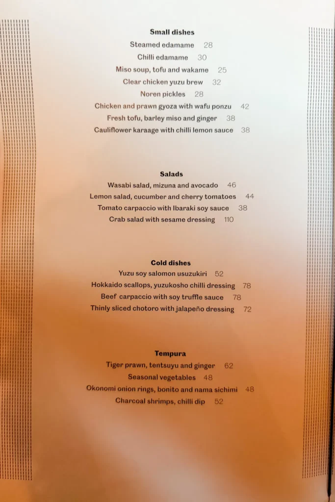 Page of Noren’s menu listing small dishes, salads, cold dishes and tempura with prices in dirhams, including edamame, gyoza, chutoro and okonomi onion rings